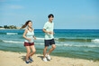© Dialogue Frame - Young Couple Running on the Beach