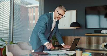 Poster - Laptop, entrepreneur and man with documents, office and planning for investment on website and corporate. Business, trading and mature person with tech for stock market, information and working