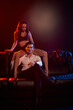 © LIGHTFIELD STUDIOS - Passionate couple embraces intimacy on a dimly lit couch, igniting romance and desire