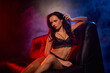 © LIGHTFIELD STUDIOS - A woman relaxes in an artistic space filled with vibrant colors and captivating lights