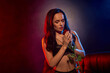 © LIGHTFIELD STUDIOS - Enchanting young woman embraces a red rose in a sultry atmosphere with captivating colors
