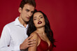 © LIGHTFIELD STUDIOS - Passionate couple embraces in alluring intimacy against a bold red backdrop creating love’s magic