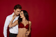 © LIGHTFIELD STUDIOS - Passion ignites between a couple in a striking red backdrop showcasing intimacy and allure