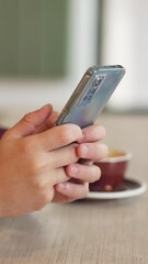Leinwandbilder - Person, hands and phone in coffee shop for social media, typing message and hospitality at table. Customer, mobile and connectivity in restaurant for online blog, service review and research in app