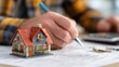 © 志华 崔 - Person Signing Documents with House Model and Keys