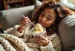 © Vladimir - Comfortable girl enjoying ice cream while relaxing on sofa at home