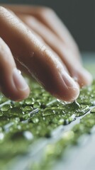 Poster - Macro Sustainability Concept Delicate Human Touch Exploring Textured Green Surface with Water Droplets - Eco-Conscious Innovation and Sensory Environmental Interaction