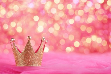 Wall Mural - sparkling golden crown on pink tulle fabric with bokeh lights background for princess theme party or