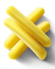 Wall Mural - close up of yellow sponge sticks stacked on white background creating a playful and inviting composi