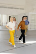 © Oleksii Syrotkin/Stocksy - Elderly couple holding hands while taking lesson at dance school