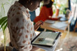 © Milles Team/Stocksy - Woman using tablet computer