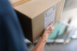 © Milles Team/Stocksy - Courier carrying box downstairs