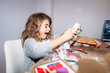© Alvaro Lavin/Stocksy - Surprised boy opening christmas gift at home