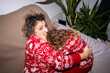 © Alvaro Lavin/Stocksy - Mother and Daughter Wearing Matching Christmas Sweaters
