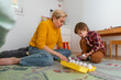 © Anna Fedorova/Stocksy - Mom and her autistic child playing with Montessori Egg Sorter