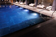© Oleksii Syrotkin/Stocksy - Partial view of spa club with swimming pools and comfortable loungers