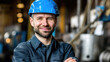 © jogeromonstero - Smiling worker in a blue hard hat,  industrial setting