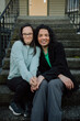 © Rob and Julia Campbell/Stocksy - Two Friends Sitting Together on Outdoor Steps.