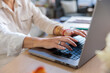 © Jovo Jovanovic/Stocksy - Closeup shot of businesswoman working on laptop at desk