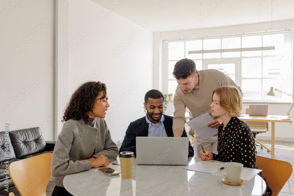 Formal business team analyzing data on laptop in modern office Stock ...