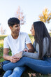 © Lupe Rodriguez/Stocksy - Latin teenage couple having fun in a city park