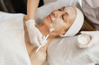 © Stereo Shot/Stocksy - Beautician applying facial cream on woman