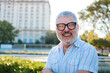 © Dani Nahuel/Stocksy - Happy mature man smiling in the city at sunset