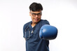 © ArvStd - Young Asian male doctor with boxing glove isolated on white background