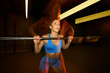 © Javier Díez/Stocksy - Weightlifting activity in a gym with dynamic lighting effects
