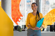© VICTOR TORRES/Stocksy - Confident professional woman holding folder in modern office