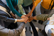 © VICTOR TORRES/Stocksy - Diverse team uniting hands in a collaborative gesture