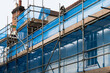 © Dave Wall/Stocksy - A building being renovated with scaffolding