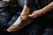 © Liliya Rodnikova/Stocksy - Closeup anonymous woman tie laces on sandals