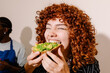 © Adrian Rodd/Stocksy - Portrait of a young woman enjoying an avocado toast