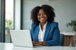 © Viktor - Smiling black woman manager works laptop in modern office. Confident businesswoman wears blue business suit. Concept of diversity success. Smiling female pro happy at workplace.