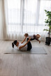 © Jovo Jovanovic/Stocksy - Happy mother is exercising with daughter at home