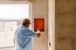 © Adrian Rodd/Stocksy - Property owner checking the progress of renovations to his home