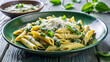 © Angavlan - Delicious spinach ricotta pasta penne topped with basil and cheese, fresh and inviting