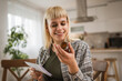 © Miljan Živković - Young woman read instruction for medical browse internet at kitchen
