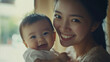 © Dirk - Portrait of happy Asian mom and baby bonding and smiling together. Happy family, beautiful background, mockup for mother’s day. Publicity poster, healthy happy family. Tender moments between mother an