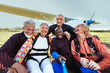 © Marko Geber - Happy senior friends taking selfie after skydiving adventure by airplane