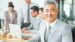 © romanets_v - Confident asian male professional smiling in meeting with colleagues