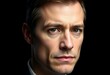 © iushakovsky - Male portrait on black background with calm expression