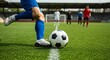 © Sabrina - A close-up shot of a football player’s feet kicking a ball on a grass field during a match
