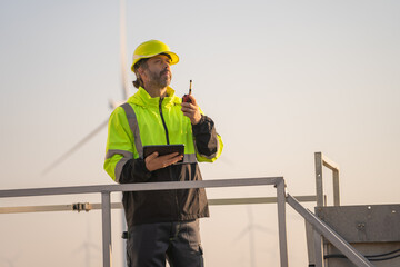 Aufkleber - Engineer man working with tablet at windmill farm Generating electricity clean energy. Wind turbine farm generator by alternative green energy.
