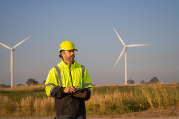 Aufkleber - Engineer man working with tablet at windmill farm Generating electricity clean energy. Wind turbine farm generator by alternative green energy.