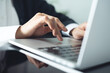 © tippapatt - Close up of business woman hands typing on laptop computer searching the information and surfing the internet on office desk, online working, telecommuting, corpoarte business concept