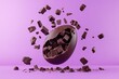 © Graphicsfuelstd - A chocolate Easter egg bursts open, showering a vibrant purple background with pieces of dark chocolate.  Chunks of chocolate are scattered in the air and on the surface