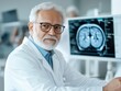 © Tetiana - Senior male doctor reviewing medical scan in office