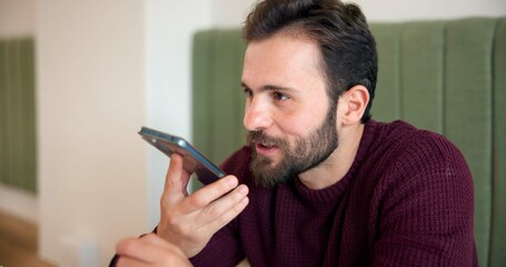 Poster - Man, phone and voice note with planning at coffee shop, listen and networking for online dating with arrangement. Person, customer and excited for talk, communication and conversation at cafe